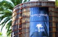 Large blue signage on old wood vats at entrance of Seppeltsfield winery.